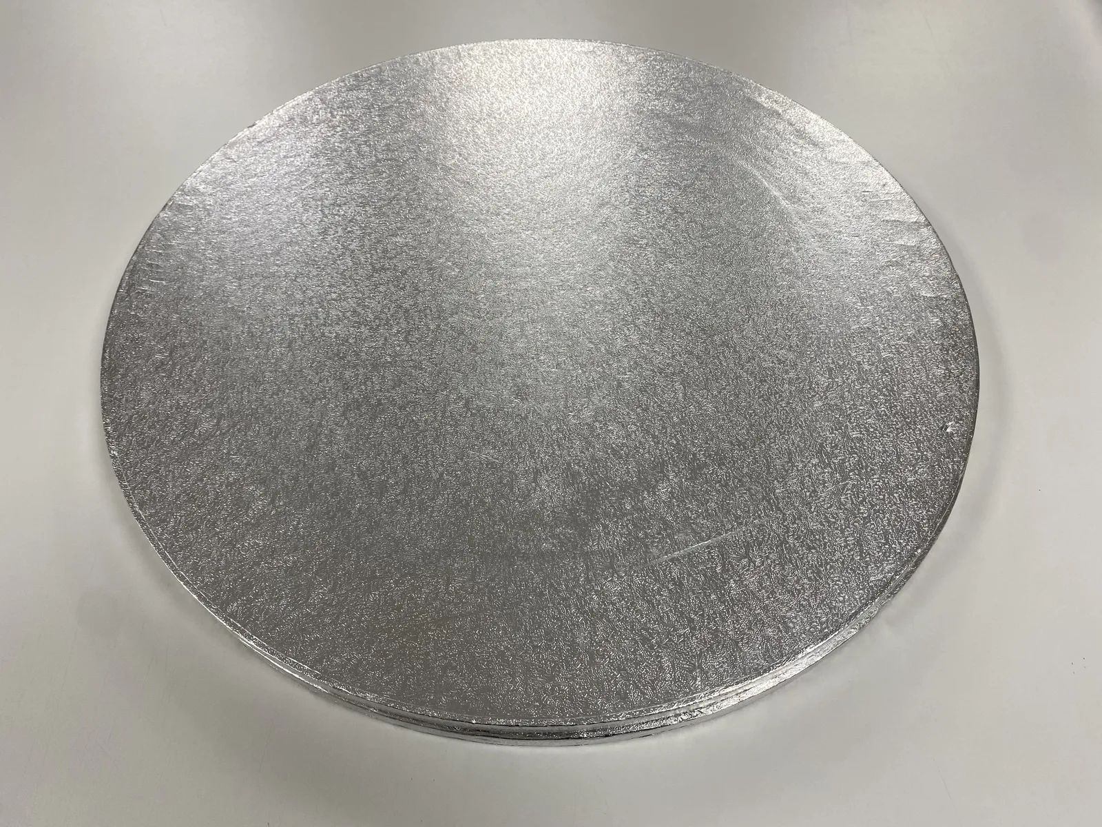 Two round 18-inch silver cake drums
