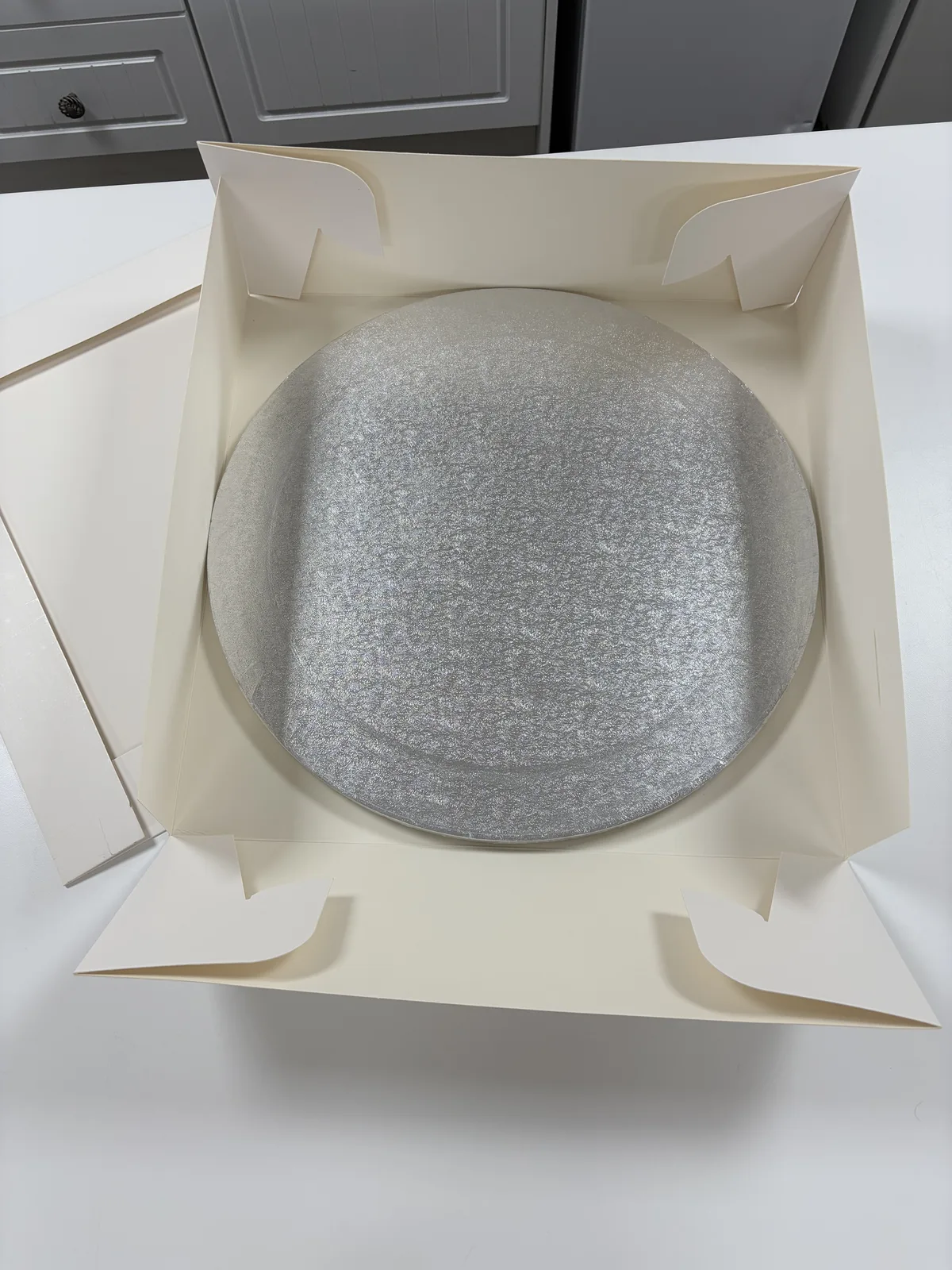 18-inch silver round cake drum in white cake box with lid