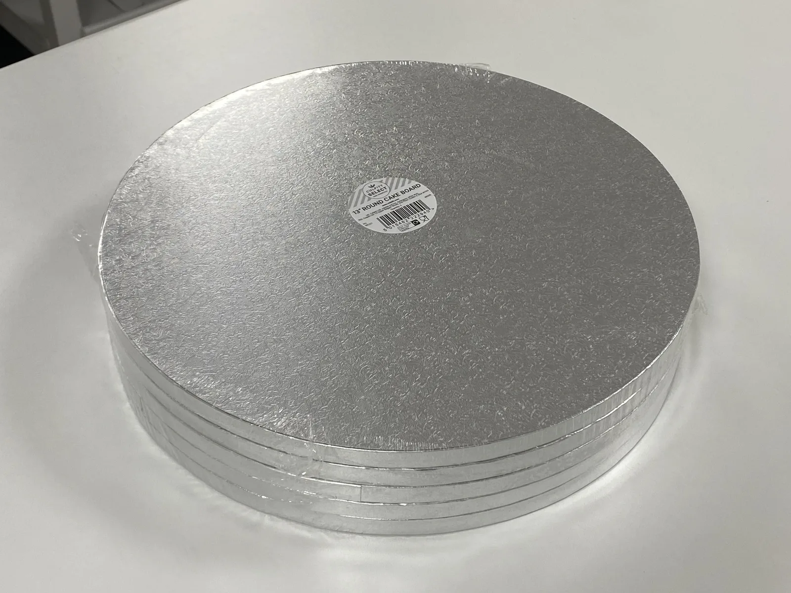 Two stacks of five round 13-inch silver cake drums